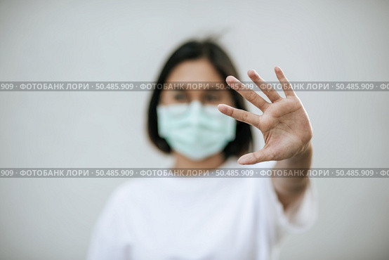 Women wear masks and forbid by raising their hands in front. Стоковое фото, агентство Ingram Publishing / Фотобанк Лори