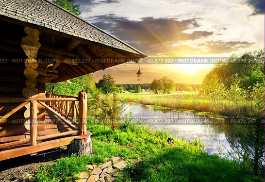 Wooden bathhouse near lake at the sunset. Стоковое фото, агентство Ingram Publishing / Фотобанк Лори