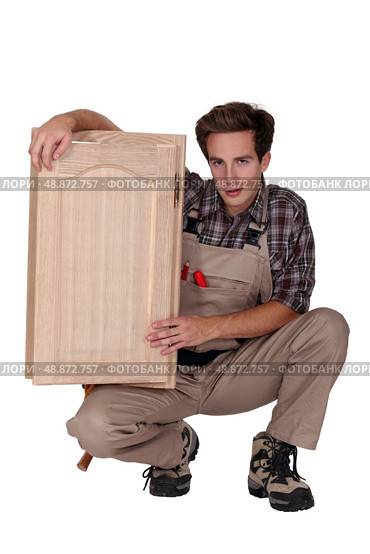 woodworker holding a window frame. Стоковое фото, агентство Ingram Publishing / Фотобанк Лори