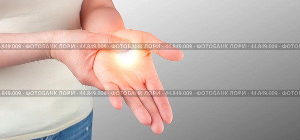 Wrist pain. Carpal tunnel syndrome, arthritis, neurological disease concept. Numbness of hand. Closeup of female arms holding his painful wrist. Стоковое фото, фотограф Павел Муравьев / Фотобанк Лори