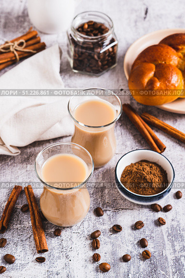 Yemeni coffee with spices and cream in glasses and crispy bread on the table vertical view. Стоковое фото, фотограф Елена Руй / Фотобанк Лори