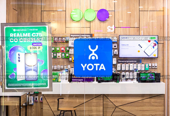Yota/Megafon phone service in the large store. Cellular communication salon Megafon, Yota. Редакционное фото, фотограф FotograFF / Фотобанк Лори