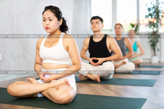 Young Asian lady performs comfortable lotus asana-Padmasana-Siddhasana pose. Стоковое фото, фотограф Яков Филимонов / Фотобанк Лори