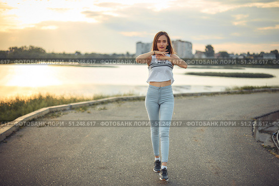 Young beautiful caucasian blonde girl listening to music with smartphone walking and dance in the city with headphones smiling - relax, youth, emancipation concept. Стоковое фото, фотограф Арзюков Вадим Николаевич / Фотобанк Лори