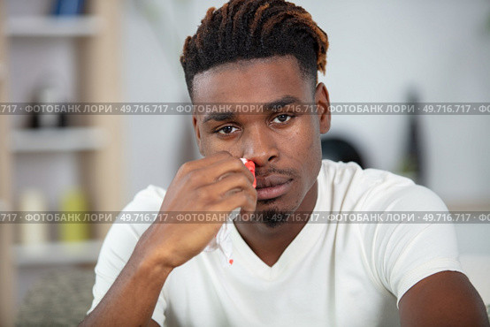 young black man suffering from sinusitis. Стоковое фото, агентство Ingram Publishing / Фотобанк Лори