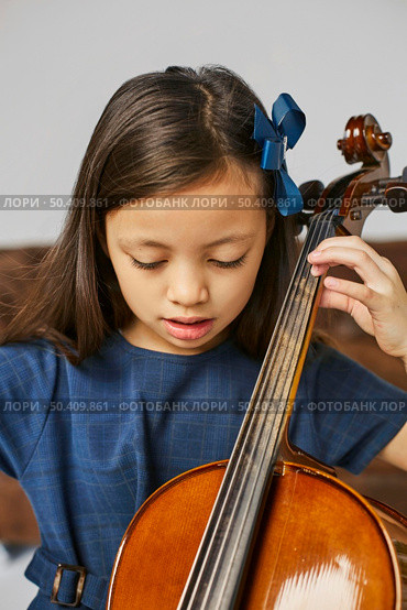 young cute girl learning how play cello. Стоковое фото, агентство Ingram Publishing / Фотобанк Лори