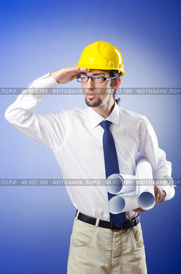 Young engineer working with drawings. Стоковое фото, агентство Ingram Publishing / Фотобанк Лори