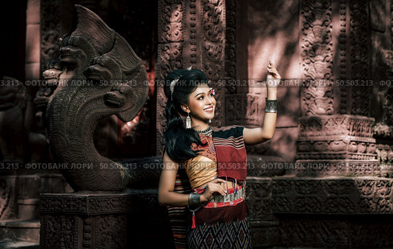 Young female Actress wearing beautiful ancient costumes, in ancient monuments, dramatic style. Perform on legend love popular story, Thai Isan folktale called "Phadaeng and Nang-ai" in acient site. Стоковое фото, агентство Ingram Publishing / Фотобанк Лори