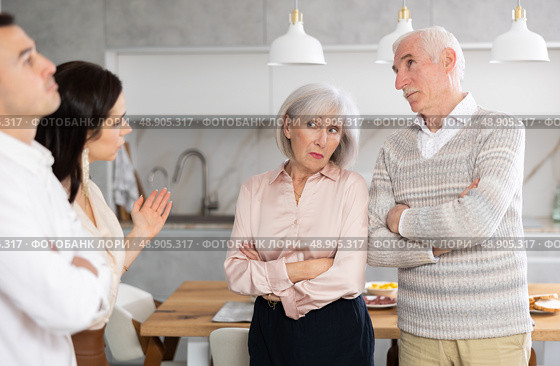 Young girl introducing her boyfriend to her discontented parents at home. Стоковое фото, фотограф Яков Филимонов / Фотобанк Лори