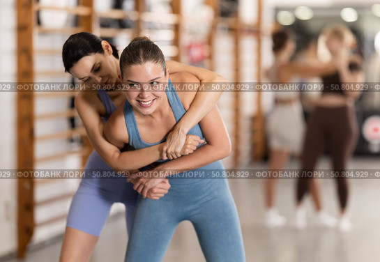 Young girl practicing self-defense techniques in pair. Стоковое фото, фотограф Яков Филимонов / Фотобанк Лори