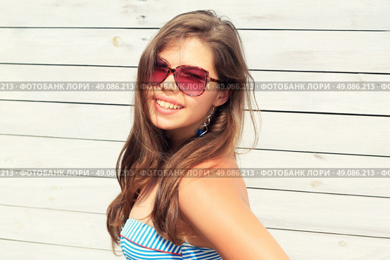 Young girl Teenager with a wooden fence, a trendy stylish portrait. Стоковое фото, агентство Ingram Publishing / Фотобанк Лори