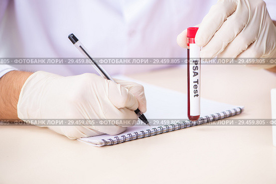 Young handsome lab assistant testing blood samples in hospital. Стоковое фото, фотограф Elnur / Фотобанк Лори
