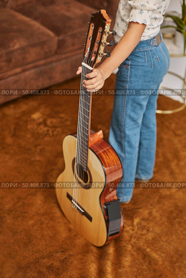 young little girl playing guitar home 3. Стоковое фото, агентство Ingram Publishing / Фотобанк Лори