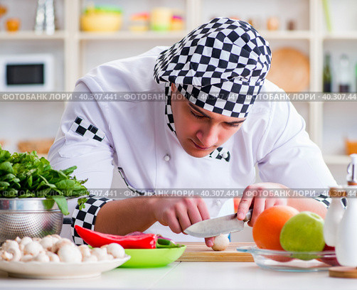 Young male cook working in the kitchen. Стоковое фото, фотограф Elnur / Фотобанк Лори