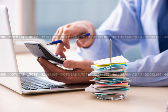 Young male employee in budget planning concept. Стоковое фото, фотограф Elnur / Фотобанк Лори