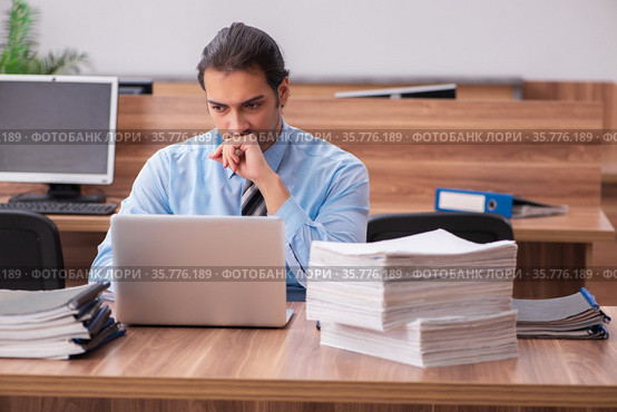Young male employee unhappy with excessive work. Стоковое фото, фотограф Elnur / Фотобанк Лори