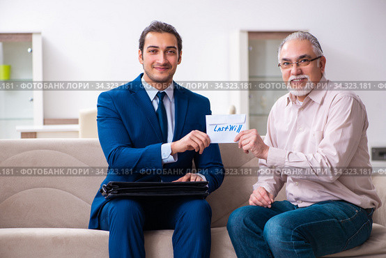Young male lawyer visiting old man in testament concept. Стоковое фото, фотограф Elnur / Фотобанк Лори