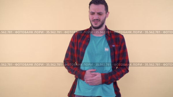 Young man suffering from strong stomach ache, feeling discomfort. Стоковое видео, видеограф Mihail Mihaylov / Фотобанк Лори