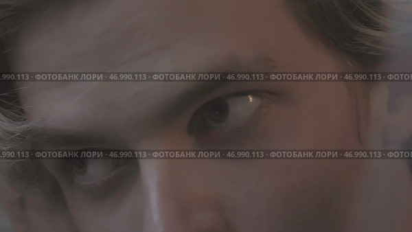 Young man wearing headphones wakes up abruptly from external sounds. Стоковое фото, фотограф David Kashakhi / Фотобанк Лори