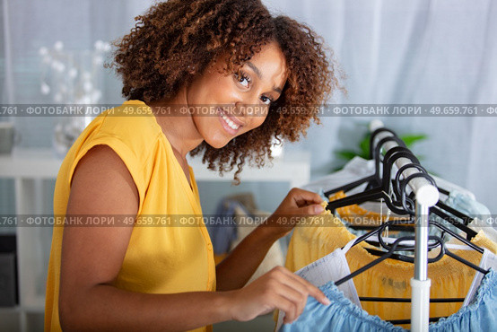 young woman deciding what to put on. Стоковое фото, агентство Ingram Publishing / Фотобанк Лори