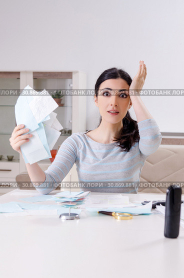 Young woman in budget planning concept. Стоковое фото, фотограф Elnur / Фотобанк Лори