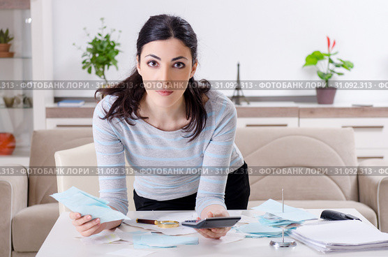 Young woman in budget planning concept. Стоковое фото, фотограф Elnur / Фотобанк Лори