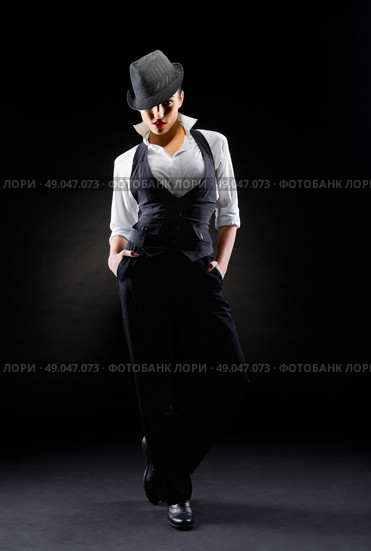 Young woman in manly style on grey background. Стоковое фото, агентство Ingram Publishing / Фотобанк Лори