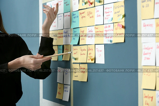 Young woman near scrum task board in office. Стоковое фото, фотограф Pixel_shot / Фотобанк Лори