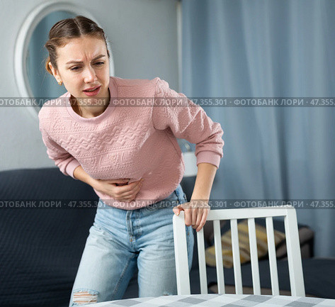Young woman suffering from abdominal pain. Стоковое фото, фотограф Яков Филимонов / Фотобанк Лори