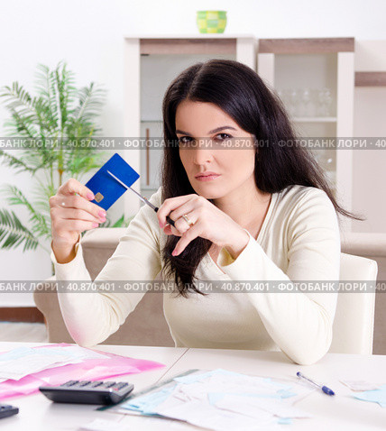 Young woman with receipts in budget planning concept. Стоковое фото, фотограф Elnur / Фотобанк Лори
