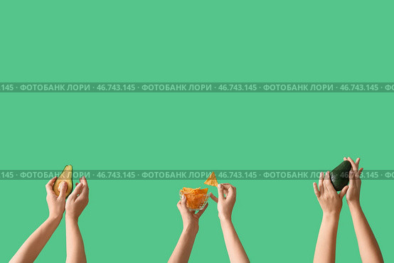 Женские руки, удерживающие нагетсы и авокадо на зеленом фоне. Стоковое фото, фотограф Pixel_shot / Фотобанк Лори